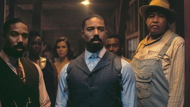This image released by Warner Bros Pictures shows Michael B. Jordan, foreground from left, Michael B. Jordan and Omar Benson Miller in a scene from "Sinners." (Warner Bros. Pictures via AP)