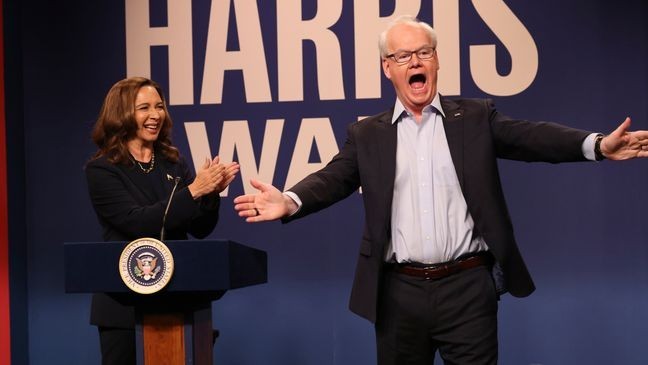 This image released by NBC shows Maya Rudolph as Kamala Harris, left, and  Jim Gaffigan as Tim Walz, during the cold open sketch on "Saturday Night Live" in New York on Saturday, Sept. 28, 2024. (Will Heath/NBC via AP)