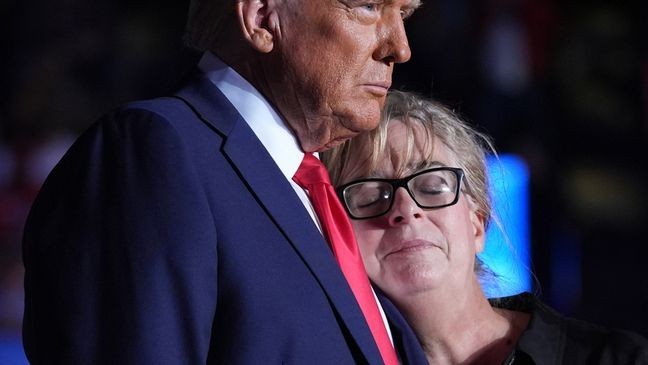 Republican presidential nominee former President Donald Trump embraces Patty Morin, mother of Rachel Morin, during a campaign rally at Santander Arena, Monday, Nov. 4, 2024, in Reading, Pa. (AP Photo/Evan Vucci)