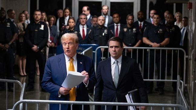 Former President Donald Trump, standing with defense attorney Todd Blanche, speaks at the conclusion of proceedings for the day at his trial at Manhattan criminal court, Tuesday, May 14, 2024, in New York. (AP Photo/Craig Ruttle, Pool)