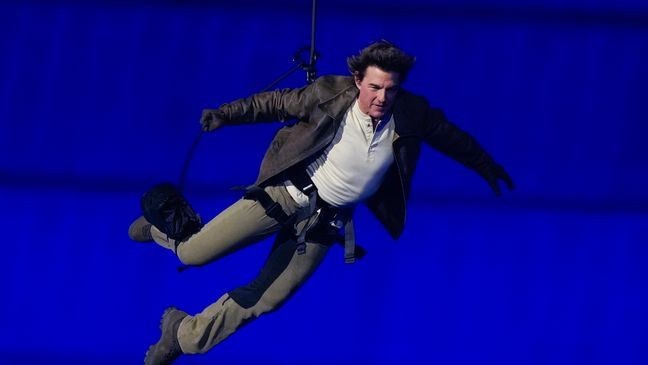 Tom Cruise is lowered on the State de France during the 2024 Summer Olympics closing ceremony, Sunday, Aug. 11, 2024, in Saint-Denis, France. (AP Photo/Natacha Pisarenko)