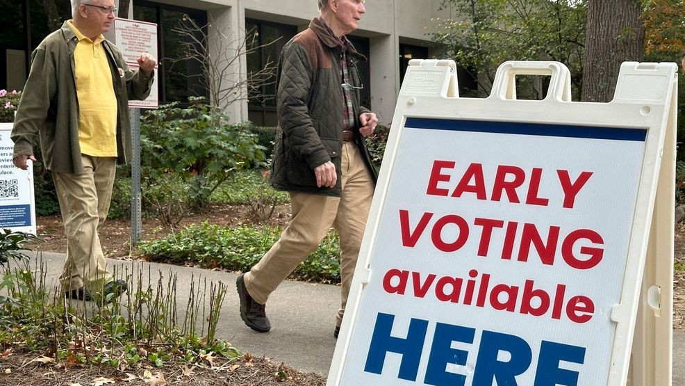 People leave after voting. (AP Photo/Jeff Amy)