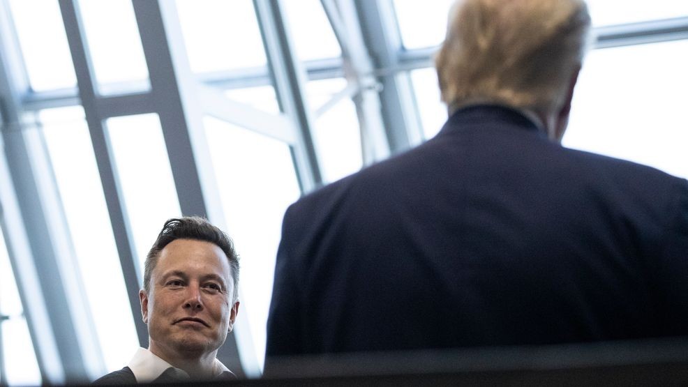 FILE - Tesla and SpaceX CEO Elon Musk talks with President Donald Trump, May 30, 2020, in Cape Canaveral, Fla. (AP Photo/Alex Brandon, File)