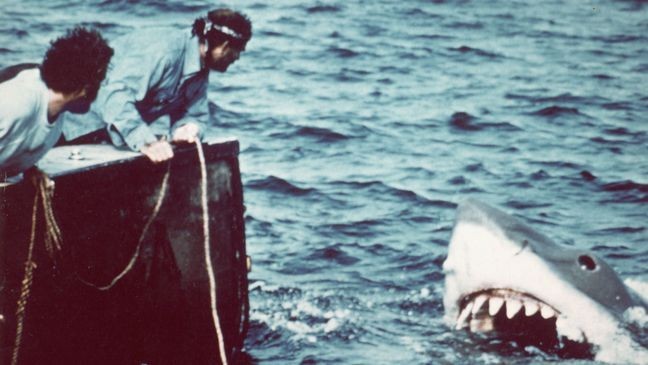 Actor Richard Dreyfuss (left) (as marine biologist Hooper) and actor Robert Shaw (as shark fisherman Quint) approach the mechanical giant shark dubbed 'Bruce' in a scene from the film 'Jaws' directed by Steven Spielberg, 1975. (Credit: Universal Pictures/Getty Images)
