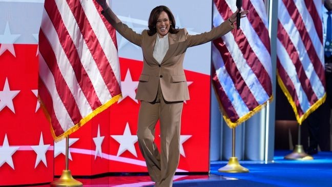 Democratic presidential nominee Vice President Kamala Harris raises her arms as she walks on stage during the Democratic National Convention Monday, Aug. 19, 2024, in Chicago. (AP Photo/J. Scott Applewhite)