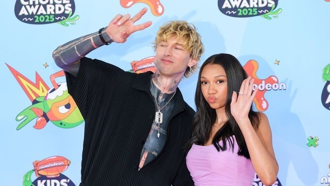 SANTA MONICA, CALIFORNIA - JUNE 21: (L-R) mgk and Casie Baker attend the 2025 Nickelodeon Kids' Choice Awards at Barker Hangar on June 21, 2025 in Santa Monica, California. (Photo by Maya Dehlin Spach/Getty Images)
