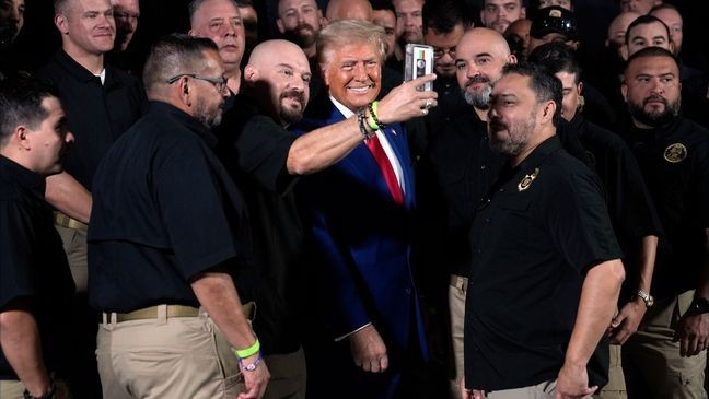 Republican presidential nominee former President Donald Trump talks with members of the U.S. Border Patrol before speaking at a campaign rally, Sunday, Oct. 13, 2024, in Prescott Valley, Ariz. (AP Photo/Evan Vucci)