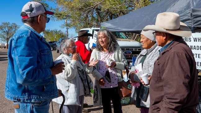 Pauline Larry, second from left, discuss community issues with fellow voters outside a polling station on the Navajo Nation in Ganado, Ariz., on Election Day, Tuesday, Nov. 5, 2024. (AP Photo/Andres Leighton)