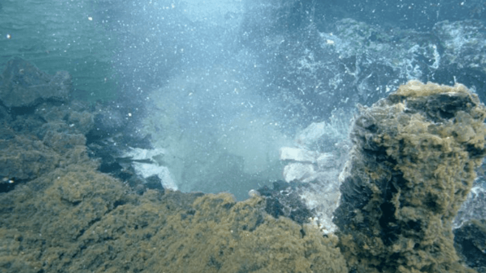 {p}Microbes and their waste material stream from this “snowblower” vent on Axial Seamount three months after its eruption in 2011. (University of Washington){/p}