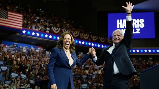 FILE - Democratic presidential nominee Vice President Kamala Harris accompanied, left, by her running mate Minnesota Gov. Tim Walz, appear at a campaign event in Philadelphia, Aug. 6, 2024. (AP Photo/Matt Rourke, File)