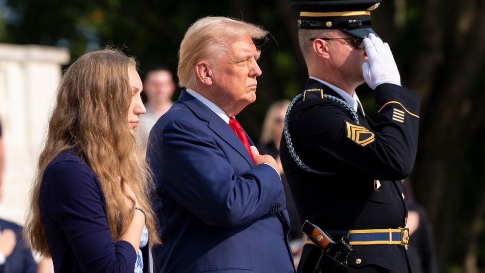 Misty Fuoco, left, sister of Nicole Gee, and Republican presidential nominee former President Donald Trump place their hands over their heart after placing a wreath in honor of Sgt. Nicole Gee, at the Tomb of the Unknown Solider at Arlington National Cemetery, Monday, Aug. 26, 2024, in Arlington, Va. (AP Photo/Alex Brandon)