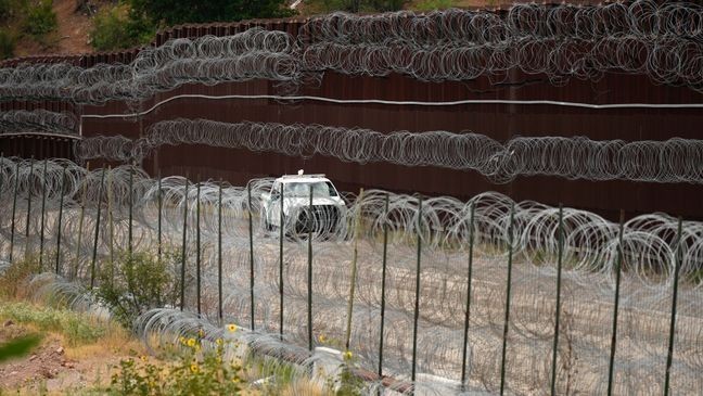 FILE - A vehicle drives along the U.S. side of the US-Mexico border wall in Nogales, Ariz. on Tuesday, June 25, 2024. (AP Photo/Jae C. Hong, Pool)