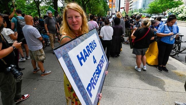 Christina Runkle with other protesters stands outside of the Chicago Hilton as Republican Presidential candidate Donald Trump addressed the National Association of Black Journalists Convention and Career Fair, Wednesday, July 31, 2024, in Chicago. (AP Photo/Matt Marton)