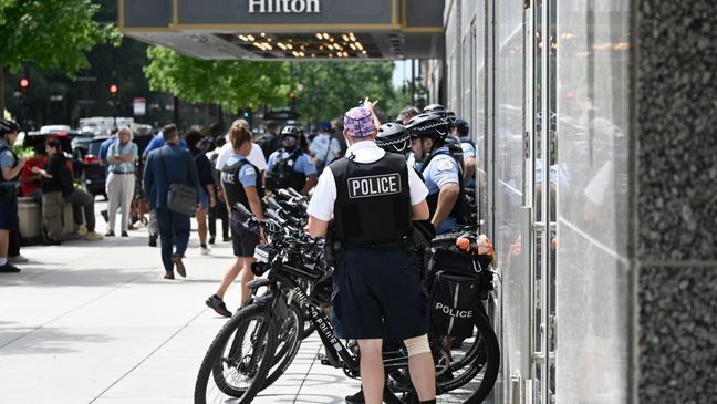 Chicago Police bike patrol members line up outside of the Chicago Hilton as Republican Presidential candidate Donald Trump addressed the National Association of Black Journalists Convention and Career Fair, Wednesday, July 31, 2024, in Chicago. (AP Photo/Matt Marton)