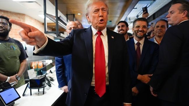 Republican presidential nominee former President Donald Trump talks as he visits The Great Commoner, Friday, Nov. 1, 2024, in Dearborn, Mich. (AP Photo/Julia Demaree Nikhinson)