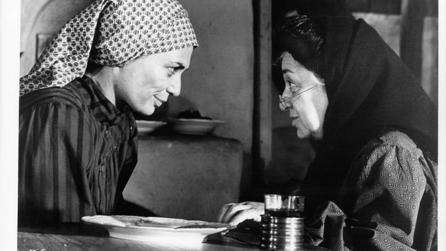 Norma Crane serves tea to Molly Picon, Yente,{ } in a scene from the film "Fiddler On The Roof." (Photo by United Artists/Getty Images)