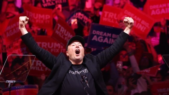 Tesla and X CEO Elon Musk raises his hands as he takes the stage during a campaign rally for Republican presidential nominee, former U.S. President Donald Trump, at Madison Square Garden on October 27, 2024, in New York City. (Photo by Michael M. Santiago/Getty Images)