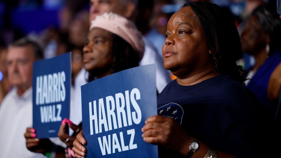 Supporters hold signs at a rally with Democratic presidential candidate, Vice President Kamala Harris at the Williams Arena at Minges Coliseum on the campus of East Carolina University on October 13, 2024, in Greenville, North Carolina. (Photo by Chip Somodevilla/Getty Images)