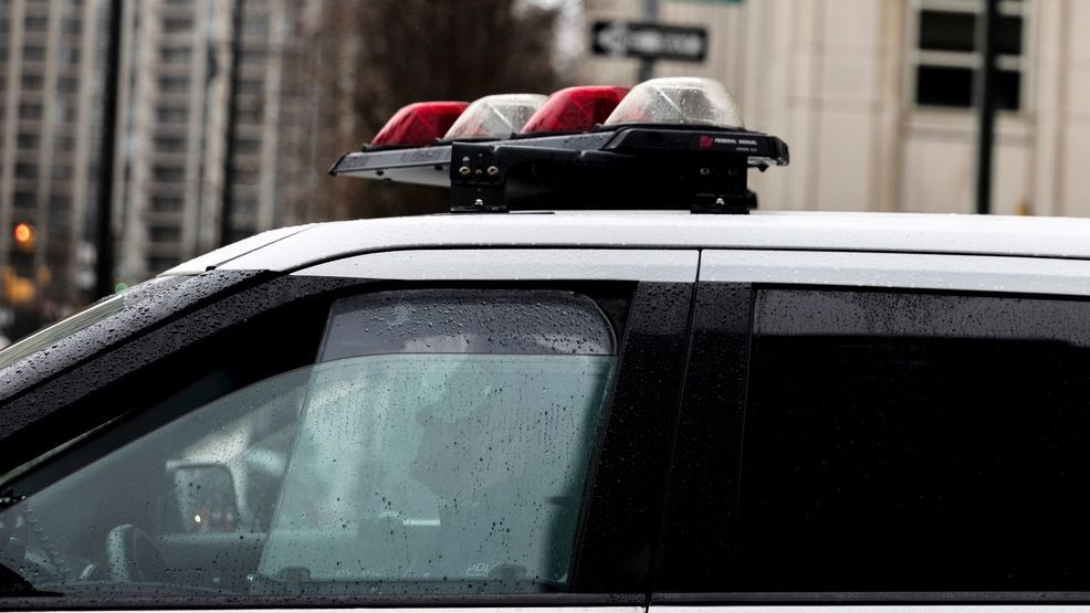 FILE - A police officer sits in a car near the Brooklyn Bridge, Dec. 16, 2022, in the Brooklyn borough of New York. (AP Photo/Julia Nikhinson, file)