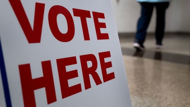 A sign directs residents to an in-person early voting location at the Kenosha Municipal Building on October 24, 2024, in Kenosha, Wisconsin. (Photo by Scott Olson/Getty Images)