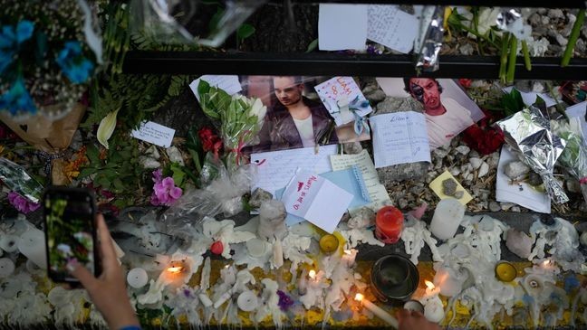 Fans of former One Direction singer Liam create a memorial outside the hotel where he was found dead after falling from a balcony in Buenos Aires, Argentina, Thursday, Oct. 17, 2024. (AP Photo/Natacha Pisarenko)