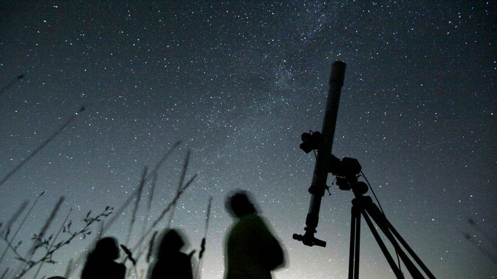 FILE - People look up to the sky at an observatory near the village of Avren east of the Bulgarian capital Sofia, Wednesday, Aug. 12, 2009. (AP Photo/Petar Petrov)