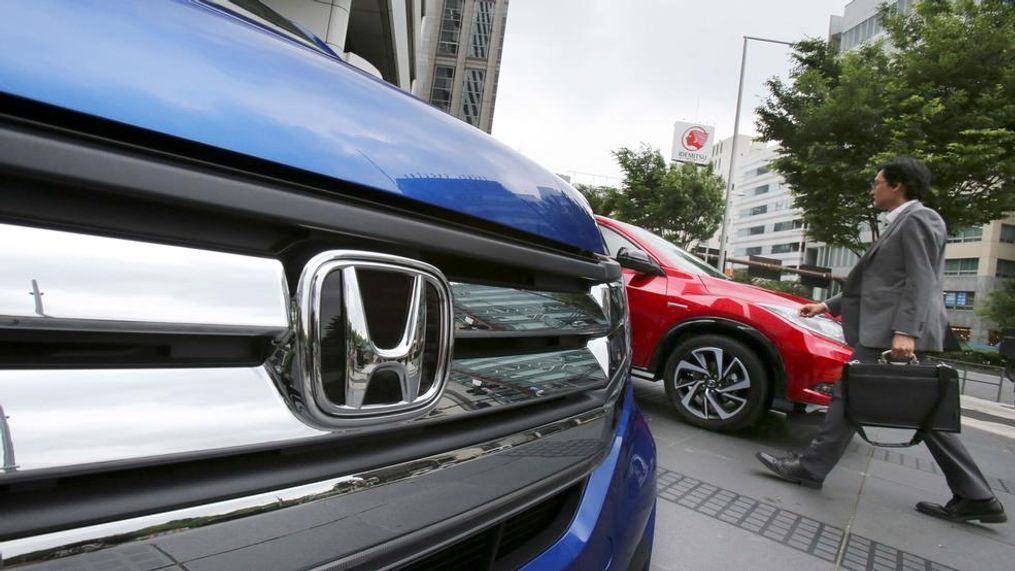 In this file photo, a man walks past a Honda car on display at Honda Motor Co. headquarters in Tokyo. Japanese automaker Honda’s fiscal second quarter profit has slipped compared to a year ago as costs related to a massive air-bag recall erased the perks of strong sales, Honda reported Wednesday, Nov. 1, 2017. (AP Photo/Koji Sasahara, File){p}{/p}