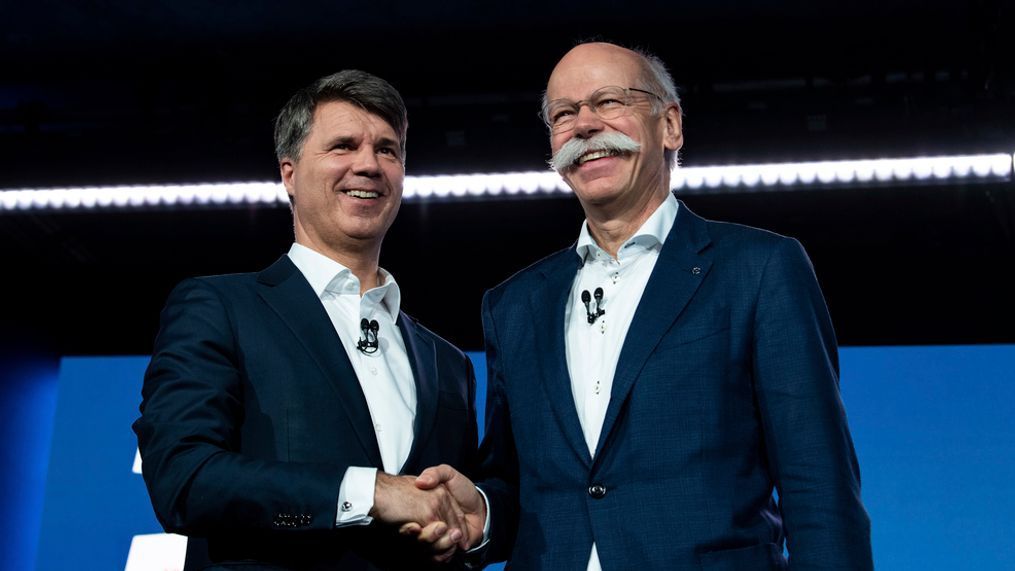 BMW CEO Harald Krueger, left, and Mercedes-Benz CEO Dieter Zetsche of Daimler, right, shake hands at a press conference in Berlin, Germany, Friday, Feb. 22, 2019. Automakers Daimler and BMW are formally launching their joint venture in services that make it possible to use their cars without necessarily owning one. (Bernd von Jutrczenka/dpa via AP)