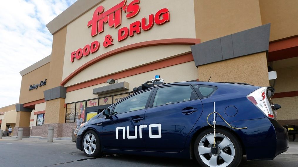 A self-driving Nuro vehicle parks outside a Fry's supermarket, which is owned by Kroger, as part of a pilot program for grocery deliveries Thursday, Aug. 16, 2018, in Scottsdale, Ariz. Kroger Co. has chosen the Phoenix suburb as a test market for delivering groceries using driverless cars. The Toyota Prius will be used for the deliveries, manned by a human to monitor its performance. During phase two in the fall, deliveries will be made by a completely autonomous vehicle, called an R1, with no human aboard. (AP Photo/Ross D. Franklin)