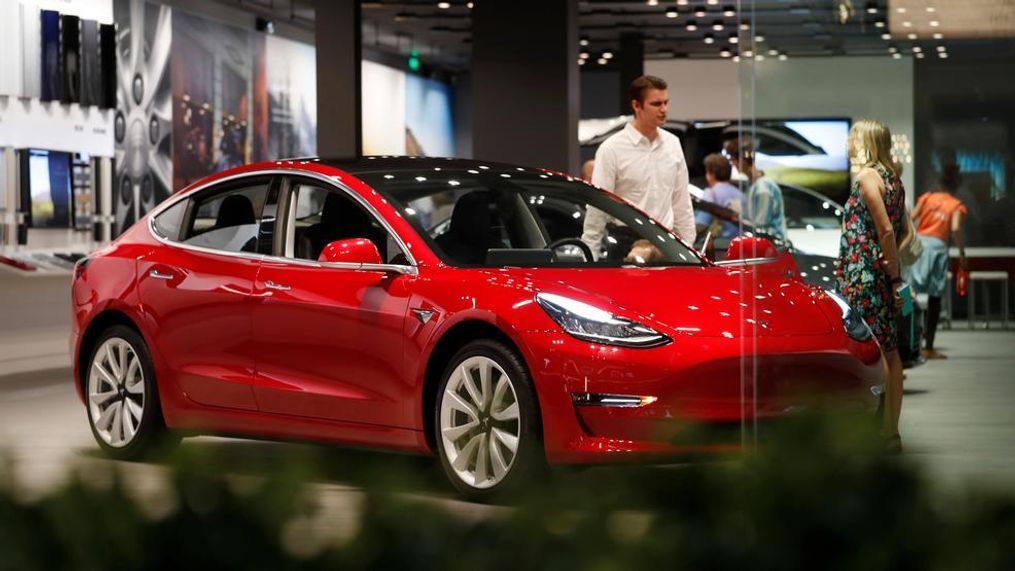 {&nbsp;}In this July 6, 2018, file photo, a prospective customer confer with sales associate as a Model 3 sits on display in a Tesla showroom in the Cherry Creek Mall in Denver.{&nbsp;} (AP Photo/David Zalubowski, File)