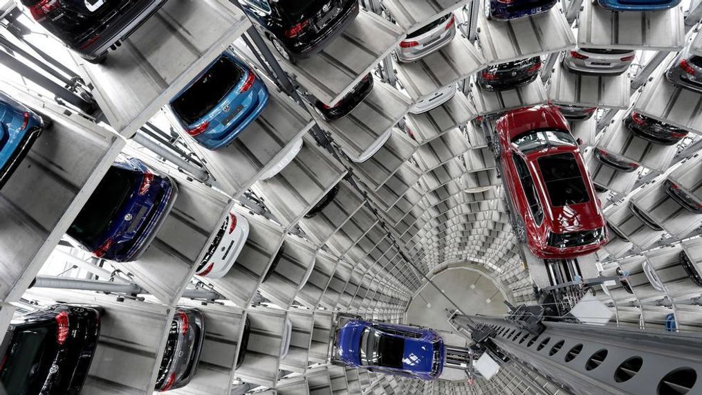 In this March 14, 2017, file photo Volkswagen cars are lifted inside a delivery tower of the company in Wolfsburg, Germany. German automaker Volkswagen saw operating profit slip in the first quarter 2019 as the company set aside 1 billion euros for legal issues but reaffirmed its profit goals for the year and saw better profits at its core brand. (AP Photo/Michael Sohn, file)