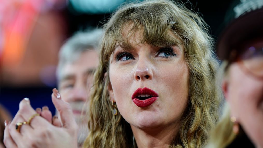 Taylor Swift stands on the field after an AFC Championship NFL football game between the Baltimore Ravens and the Kansas City Chiefs, Sunday, Jan. 28, 2024, in Baltimore. The Kansas City Chiefs won 17-10. (AP Photo/Julio Cortez)