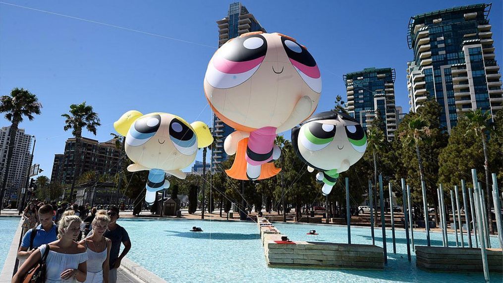 Fans walk past floating Cartoon Network Powerpuff Girls on day one of Comic-Con International held at the San Diego Convention Center Thursday, July 21, 2016, in San Diego.  (Photo by Denis Poroy/Invision/AP)