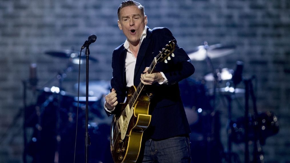 FILE- In this April 3, 2016, file photo, Bryan Adams performs at the Juno Awards in Calgary, Alberta. (Jeff McIntosh/The Canadian Press via AP, File)