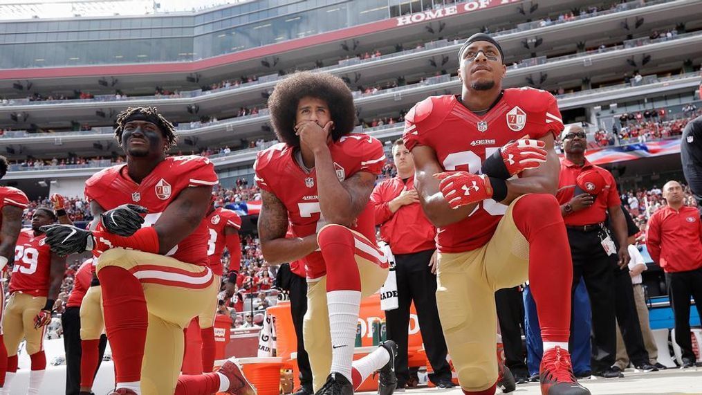 San Francisco 49ers outside linebacker Eli Harold, left, quarterback Colin Kaepernick, center, and safety Eric Reid kneel during the national anthem before an NFL football game against the Dallas Cowboys in Santa Clara, Calif., Sunday, Oct. 2, 2016. (AP Photo/Marcio Jose Sanchez)