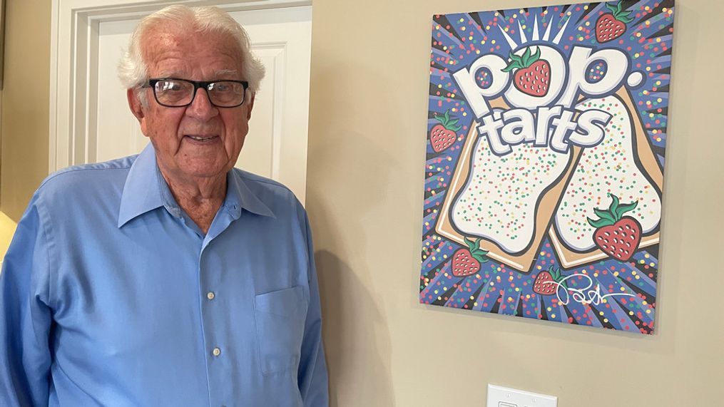 Bill Post, the 'Father of the Pop-Tart,' smiles in front of a custom size made for him by Kellogg Company. He passed away Feb. 14, 2024. (WWMT/Lexie Petrovic)