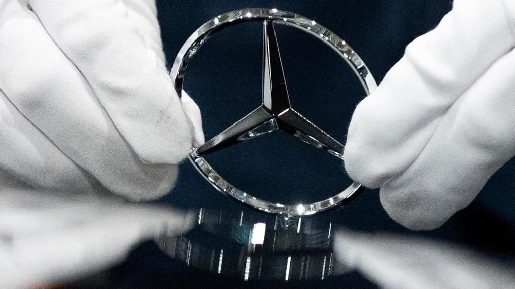 In this file photo dated Wednesday, April 3, 2019, a worker wipes a logo of a car at the Mercedes Benz automobile assembly plant outside Moscow, Russia.  German automaker Daimler expects pretax profits this year to be significantly lower than 2018, after setting aside more money to tackle the fallout from its diesel emissions problems and an airbag recall.(AP Photo/Pavel Golovkin, FILE)