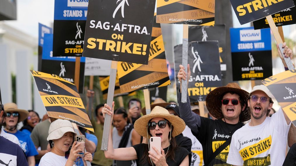 FILE - Picketers carry signs on the picket line outside Netflix on Wednesday, Sept. 27, 2023, in Los Angeles.{&nbsp;} (AP Photo/Chris Pizzello)