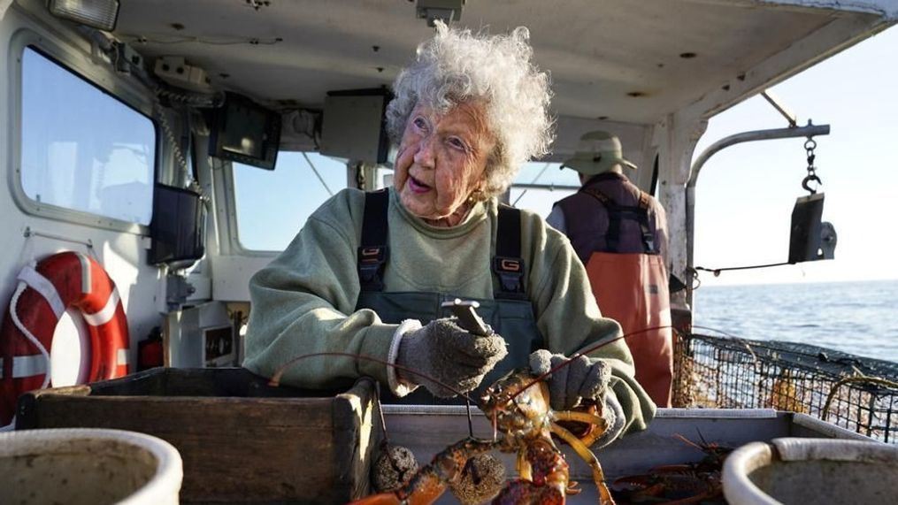 FILE - Virginia Oliver, then age 101, works as a sternman, measuring and banding lobsters on her son Max Oliver's boat, Tuesday, Aug. 31, 2021, off Rockland, Maine. The state's oldest lobster harvester has been doing it since before the onset of the Great Depression. (AP Photo/Robert F. Bukaty)