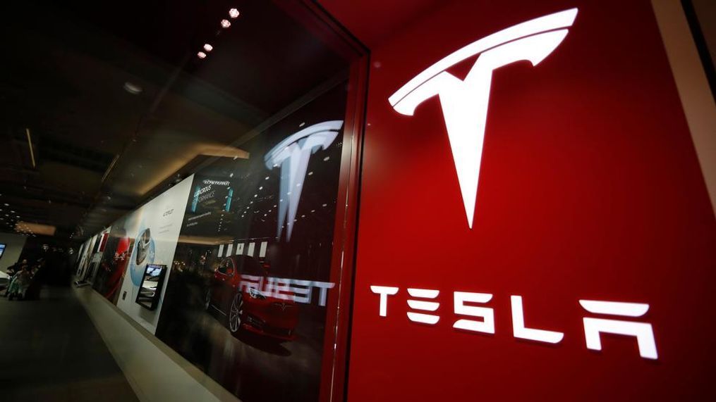 In this Feb. 9, 2019, file photo, a sign bearing the company logo is displayed outside a Tesla store in Cherry Creek Mall in Denver.{&nbsp;} (AP Photo/David Zalubowski, File)