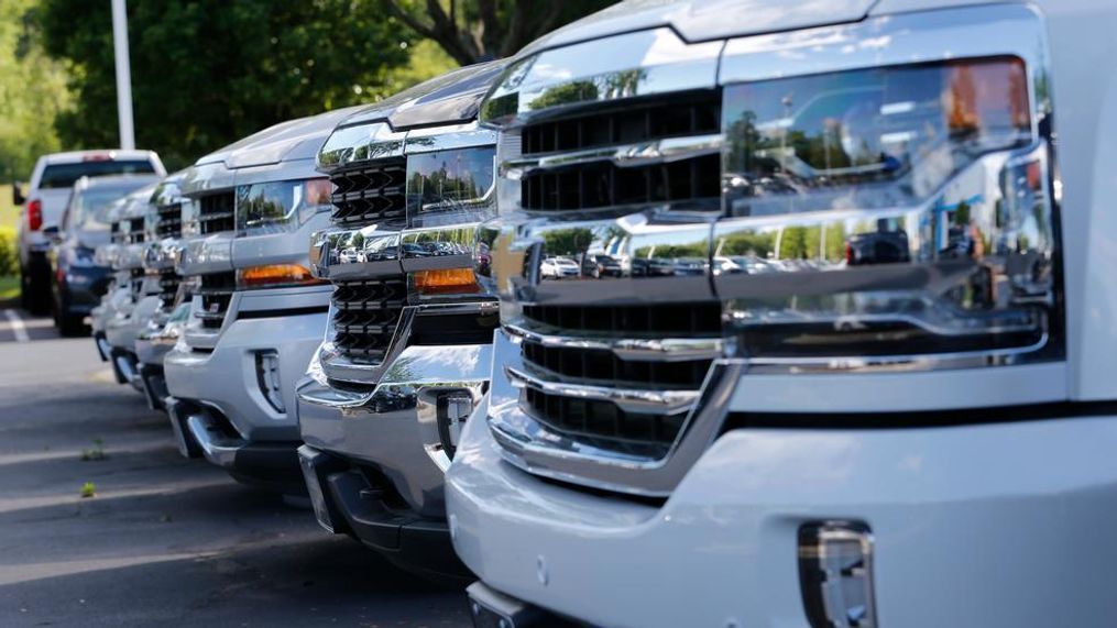 In this Wednesday, April 26, 2017, photo, trucks are lined up in the lot at a dealership in Richmond, Va. Consumers cut back on their shopping in August by the largest amount in six months as a big drop in auto sales offset gains in other areas, according to information released Friday, Sept. 15, 2017, by the Commerce Department. (AP Photo/Steve Helber)