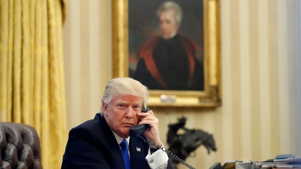 President Donald Trump speaks on the telephone in the Oval Office of the White House in Washington. In the background is a portrait of former President Andrew Jackson which Trump had installed in the first few days of his administration. Jon Meacham, who wrote a 2008 biography of Jackson titled "American Lion,” said Trump has echoed Jackson's outsider message to rural America by pledging to be a voice for "forgotten men and women." But he says it's "not the cleanest analogy." (AP Photo/Alex Brandon, File)