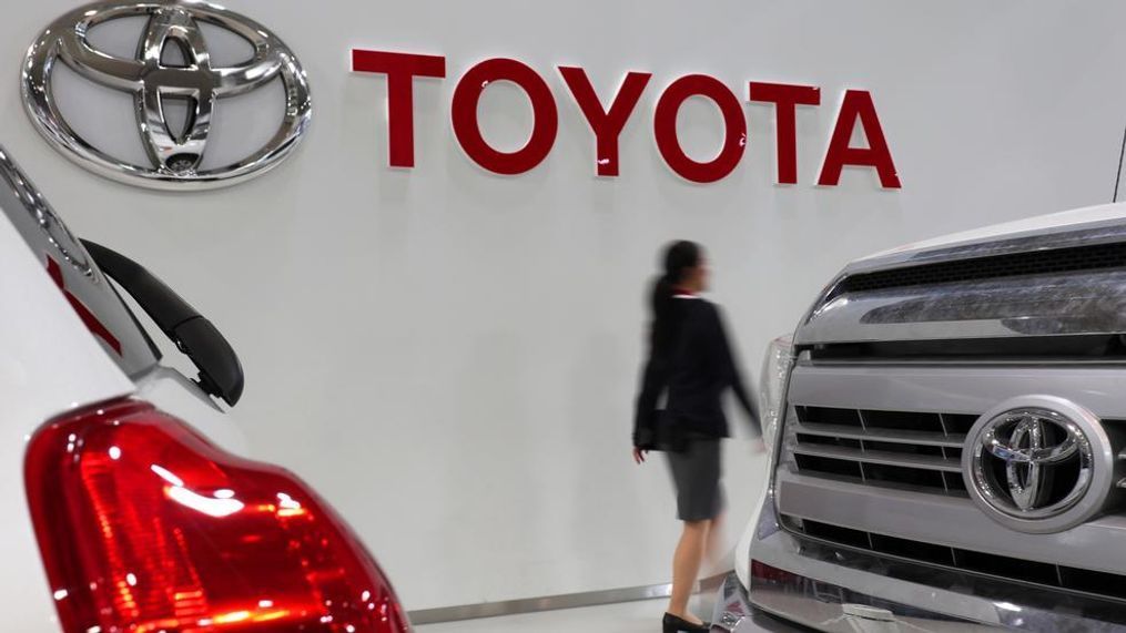 In this May 10, 2017, file photo, a visitor walks past the logo of Toyota Motor Corp. at a Toyota showroom in Tokyo. Toyota Motor Corp. said Wednesday, Jan. 30, 2019, it sold 10.59 million vehicles globally last year, fewer than the 10.83 million delivered by German rival Volkswagen AG. (AP Photo/Shizuo Kambayashi, File)