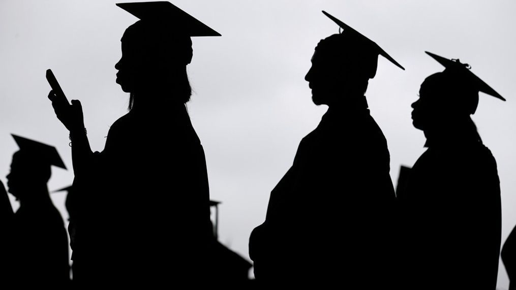 FILE - New graduates line up before the start of a community college commencement in East Rutherford, N.J., May 17, 2018. (AP Photo/Seth Wenig, File)