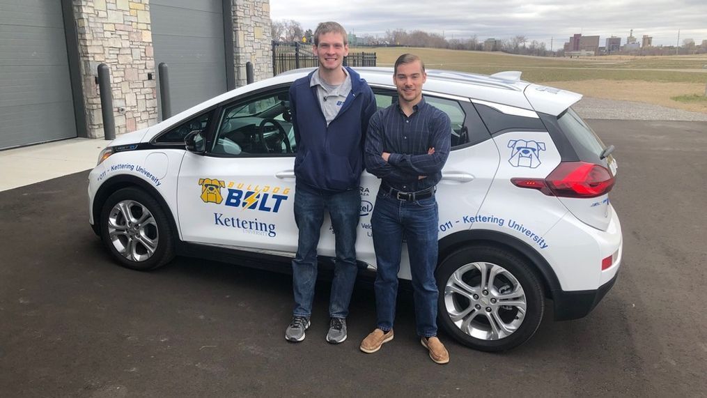 Kettering University Auto Drive Challenge team members Charlie Gates (L) and Eric Smith (R) standing with one of the Chevrolet Bolt EV models they use to develop autonomous driving technology.{&nbsp;} (Photo: Mike Woolfolk){p}{/p}