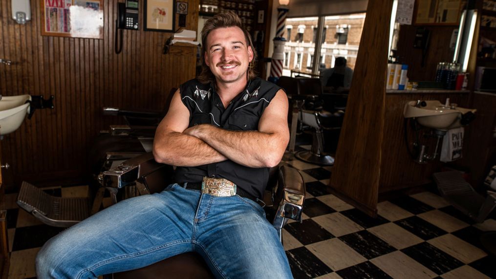 FILE - In this Aug. 27, 2019 file photo, Country singer Morgan Wallen poses for a portrait after getting a mullet at Paul Mole Barber Shop on , in New York.  Wallen wasn’t allowed to compete at this month’s Academy of Country Music Awards because the singer was caught on camera using a racial slur earlier this year, but he’s one of the top nominees at the 2021 Billboard Awards.  (Photo by Charles Sykes/Invision/AP, File)