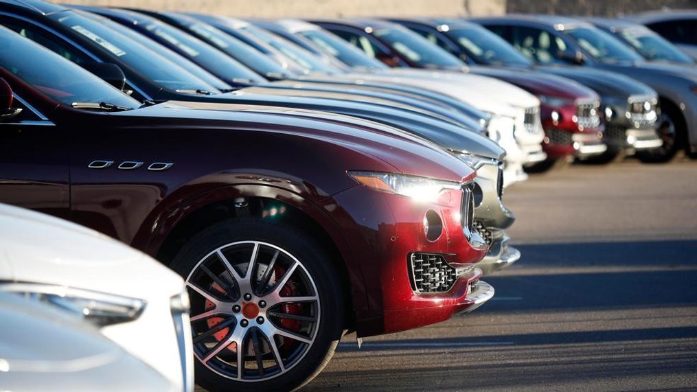 In this Sunday, Jan. 7, 2018, photograph, sun glints off the headlight housing of an unsold 2018 Maserati Levante in a long line of the high-end sports utility vehicles sitting on a dealer's lot in Highlands Ranch, Colo. On Wednesday, March 14, 2018, the Commerce Department releases U.S. retail sales data for February. (AP Photo/David Zalubowski)