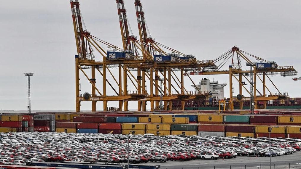 Cars for export and import are stored in front of containers on Thursday, May 16, 2019 at the harbor in Bremerhaven, Germany, with 2 million vehicles per annum one of the largest automobile hubs in the world. US President Donald Trump is delaying any decision to impose tariffs on car and auto-part imports for now. (AP Photo/Martin Meissner)