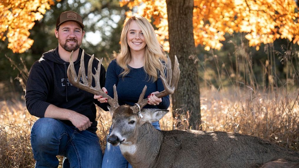 Cole Bures and Samantha Camenzind pose with the deer she shot near Filley, Neb., before he proposed to her on Nov. 12, 2023. Bures asked Camenzind to marry him during a photo shoot to commemorate the moment. (Brenton Lammers/Lammers Media via AP)