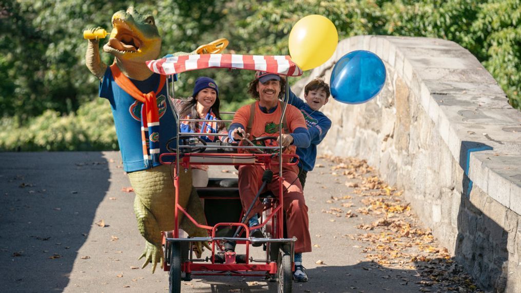 (l to r) Lyle (Lyle the Crocodile), Mrs. Primm (Constance Wu), Hector P. Valenti (Javier Bardem) and Josh Primm (Winslow Fegley) ride a pedal bike in New York in Columbia Pictures LYLE, LYLE, CROCODILE.  Photo by: Sarah Shatz